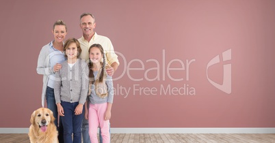 Family standing together with dog in room with wooden floor