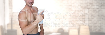 Fit strong Man in gym holding drink