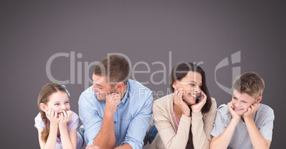 Family laughing together with grey background