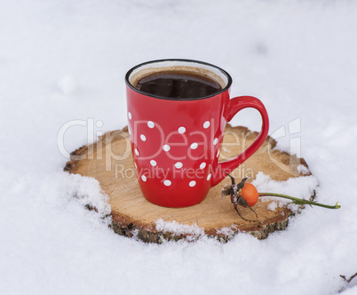 black coffee in a red ceramic mug in a white polka-dot