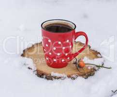 black coffee in a red ceramic mug in a white polka-dot