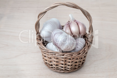 Garlic in a wicker basket on the table.