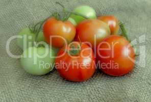 Ripe and green tomatoes on a linen fabric