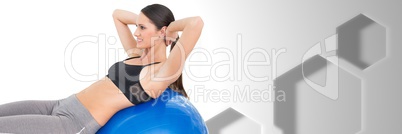 Fit athletic woman in gym with Hexagons and exercise ball