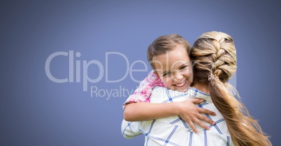 Mother hugging daughter with blue background