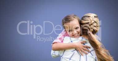 Mother hugging daughter with blue background