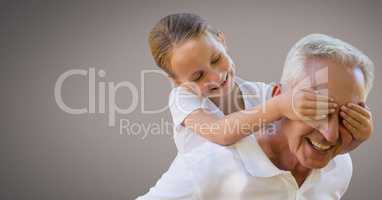 Grandfather and daughter having fun playing with brown background