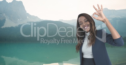 woman smiling with ok sign in the mountains