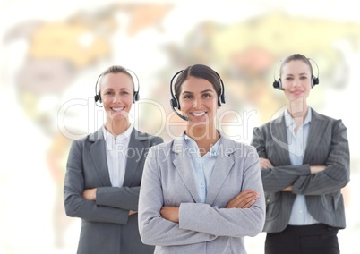 Travel agents wearing headset in front of world map