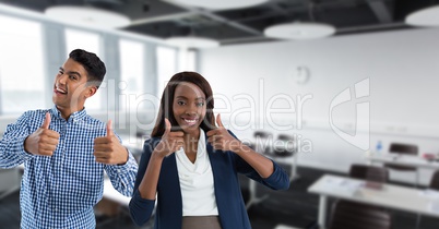 teachers in classroom smiling with thumbs up