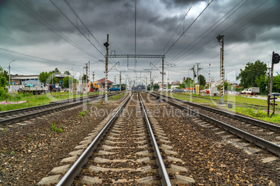 Cars cross the railroad tracks on the asphalted railroad crossing