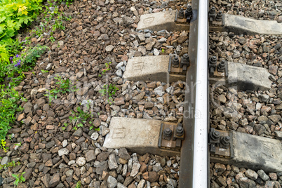 Old rusty railway. Between the concrete sleepers is one wooden sleeper with measuring sensors
