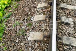 Old rusty railway. Between the concrete sleepers is one wooden sleeper with measuring sensors