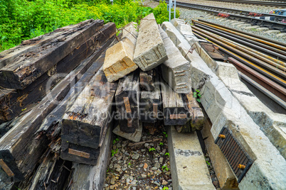 Old wooden and concrete sleepers stacked for disposal.