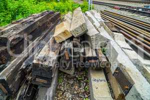 Old wooden and concrete sleepers stacked for disposal.