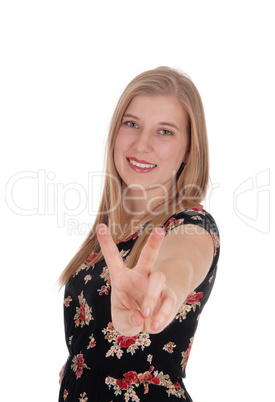 Woman making victory sign and smiling