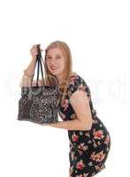Young pretty woman standing her handbag