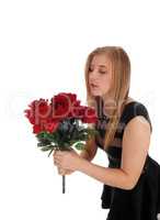 Beautiful woman with a big bunch red roses