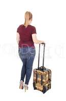 Woman standing from back with suitcase