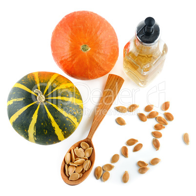 Oil, seeds and pumpkin fruits isolated on white background.