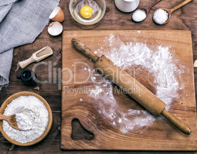 square wooden kitchen board with rolling pin