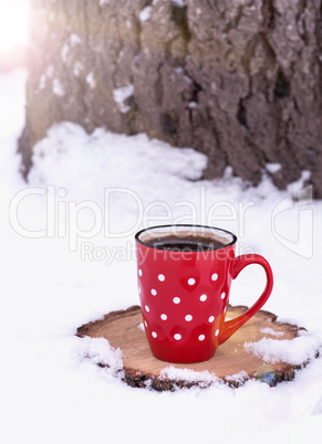 ceramic red cup with white polka dots with black coffee