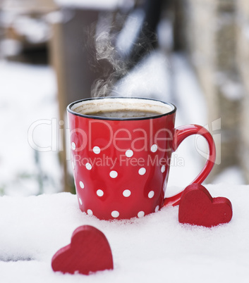 red ceramic mug with black coffee