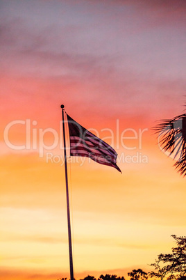 American flag blows in the wind  at sunrise