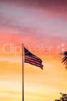 American flag blows in the wind  at sunrise