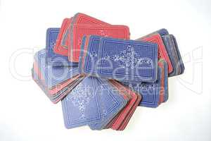 Scattered deck of face down cards isolated on white background