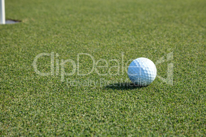 Golf ball and flag on Lush green grass