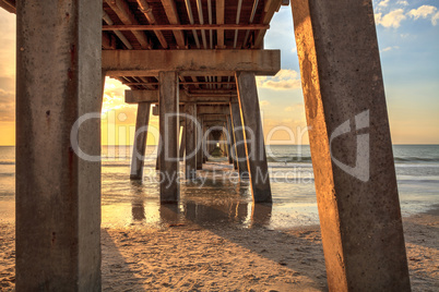 On the beach under the Naples Pier at sunset
