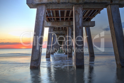 On the beach under the Naples Pier at sunset