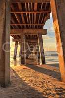 On the beach under the Naples Pier at sunset