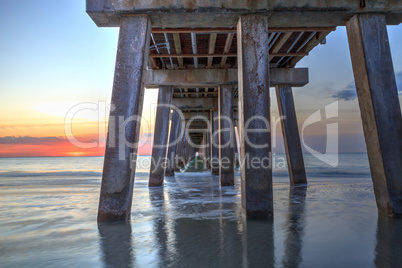 On the beach under the Naples Pier at sunset