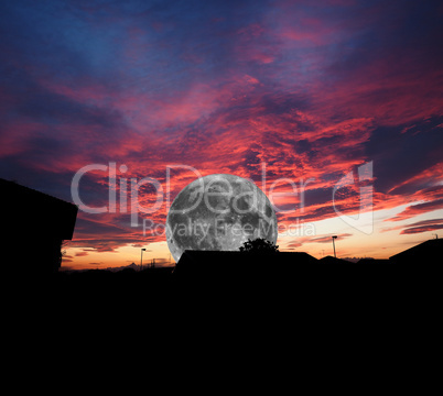 Full moon over dramatic red sky