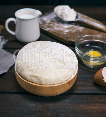 wheat yeast dough in a wooden bowl