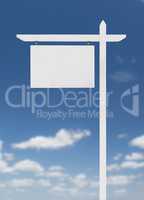 Blank Real Estate Sign Over A Blue Sky with Clouds.