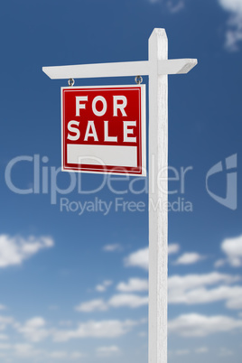 Left Facing For Sale Real Estate Sign on a Blue Sky with Clouds.