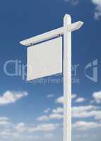 Blank Real Estate Sign Over A Blue Sky with Clouds.