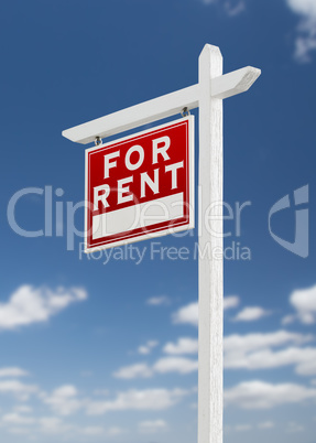 Left Facing For Rent Real Estate Sign on a Blue Sky with Clouds.