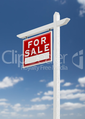 Left Facing For Sale Real Estate Sign on a Blue Sky with Clouds.