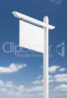 Blank Real Estate Sign Over A Blue Sky with Clouds.