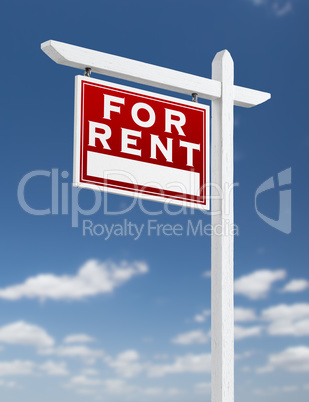 Left Facing For Rent Real Estate Sign on a Blue Sky with Clouds.