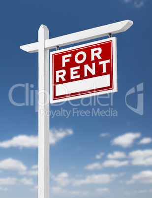 Right Facing For Rent Real Estate Sign on a Blue Sky with Clouds