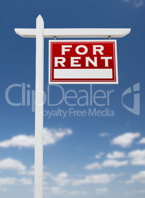 Right Facing For Rent Real Estate Sign on a Blue Sky with Clouds