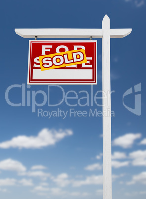 Left Facing Sold For Sale Real Estate Sign on a Blue Sky with Cl