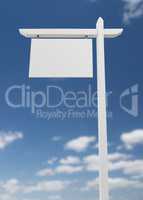 Blank Real Estate Sign Over A Blue Sky with Clouds.