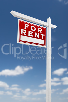 Left Facing For Rent Real Estate Sign on a Blue Sky with Clouds.