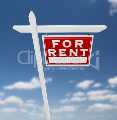 Right Facing For Rent Real Estate Sign on a Blue Sky with Clouds